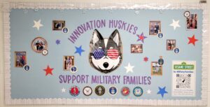 Bulletin board display that reads "Innovation Huskies support military families"